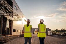 Female engineers overseeing construction site